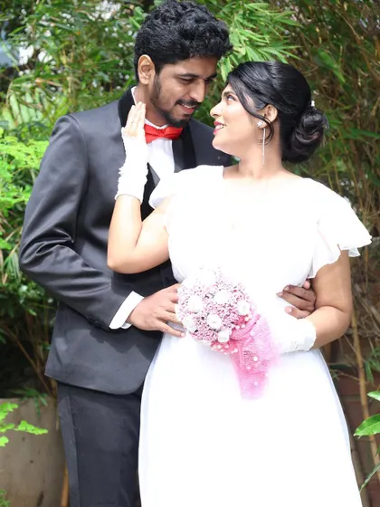 A candid moment of the couple looking at each other. The bride's makeup is fresh and radiant, perfect for this outdoor wedding photoshoot.