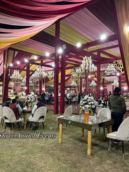Guests seated at elegantly arranged tables in a large, open-sided marquee, demonstrating our ability to cater to large gatherings.