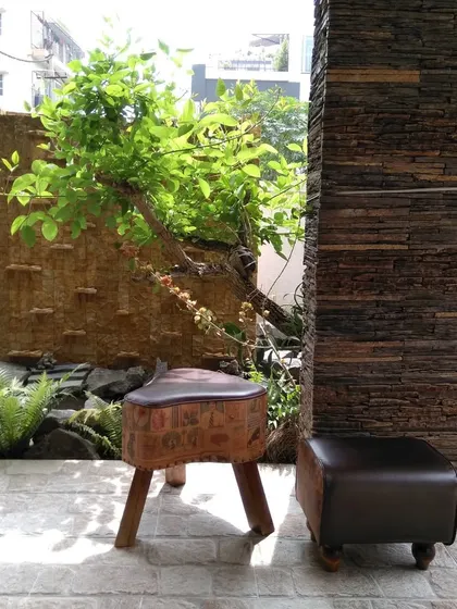 A seating area next to the water feature, showing how we integrate relaxation spots into our landscape designs for you to enjoy the sights and sounds of nature.