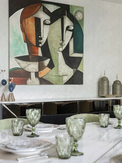 A view of one of our elegantly styled dining rooms. We focus on combining statement lighting, comfortable seating, and high-quality materials like marble and brass to create spaces that are perfect for both everyday meals and special occasions.
