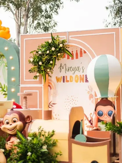 A closer look at the main stage for Mireya's boho-themed party. The design features a mix of geometric arches, a hot air balloon prop, and cute animal figures, all in a soft, earthy color palette.
