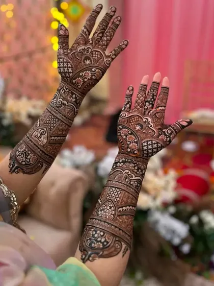A beautiful bridal design captured in a real wedding setting. The intricate patterns look stunning against the festive background.