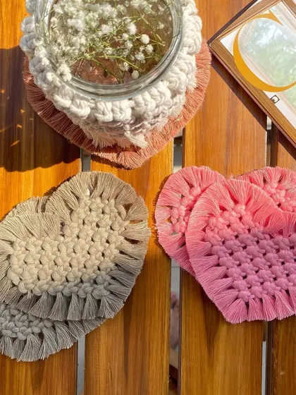 A beautiful flat-lay of our macrame heart coasters and a macrame-covered mason jar. These small, handmade details can completely transform the vibe of your space.