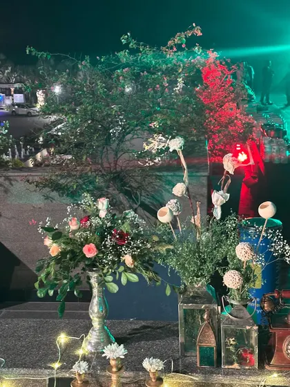 More decor details from the corporate party, showing floral arrangements and soft lighting.