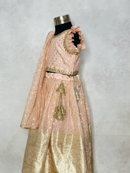 A side view of the periwinkle lehenga, showing the flutter sleeves and the flow of the skirt.