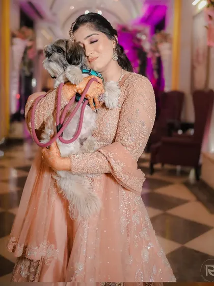 A sweet moment during a Sufi-themed Sangeet night, where the bride shares a hug with her furry friend. It's a heartwarming, candid shot.