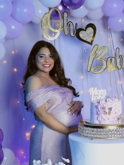 This shimmering off-the-shoulder gown is a wonderful choice for a baby shower. The stretchable fabric ensures a comfortable fit, while the metallic sheen looks beautiful under party lights.