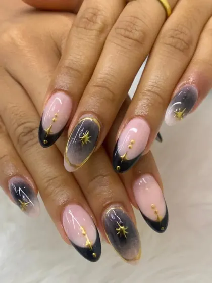A celestial-inspired look with a black and grey ombre, gold accents, and tiny star details for a touch of magic.