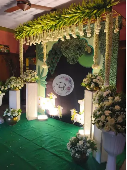 Another view of the Pichwai engagement decor, showing the full setup with floral pillars. The balance of traditional art and fresh flowers is what makes these designs so special.