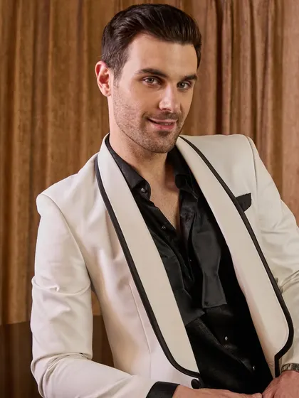 A detailed view of the white tuxedo jacket's construction. Notice the clean lines of the lapel and the perfect placement of the pocket square. It's this attention to detail that elevates a garment from simply clothing to a piece of art.