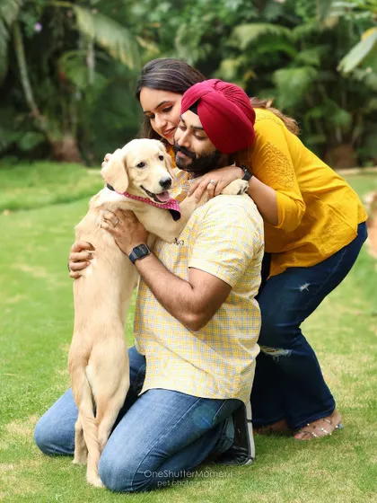 A beautiful family hug. This outdoor portrait captures a moment of pure love and connection between a couple and their adorable puppy.