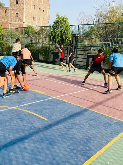 Players practice their defensive stance and footwork during a drill.