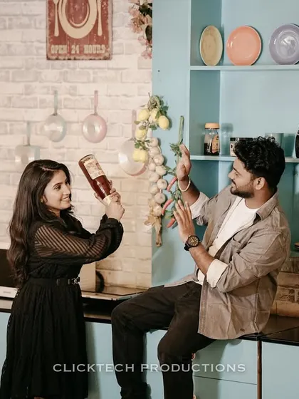 A quirky and interactive shot of a couple playing with props in a retro kitchen set.