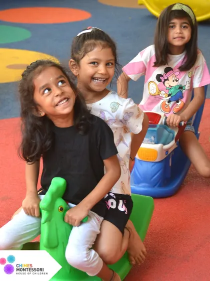 Three friends share a rocker on the playground, learning to take turns and enjoy collaborative play.
