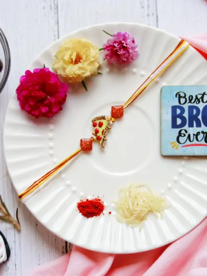 A celebration of the beautiful bond between siblings. I prepared this Rakhi thali with a vibrant rakhi, fresh flowers, and traditional elements, adding a fun pizza charm for the "Best Bro Ever."