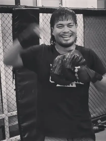 The joy of training. A fighter smiles during a session, showing the passion that fuels the grind of becoming a professional athlete.