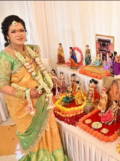 Another shot of the radiant mother-to-be proudly standing next to the detailed doll display we created for her 'dohale jevan'.