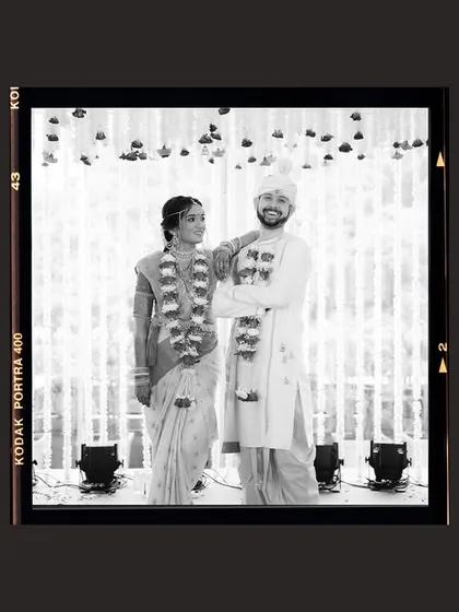 A classic portrait with a vintage film border. This black and white shot of the couple gives a timeless, documentary feel to their wedding day.