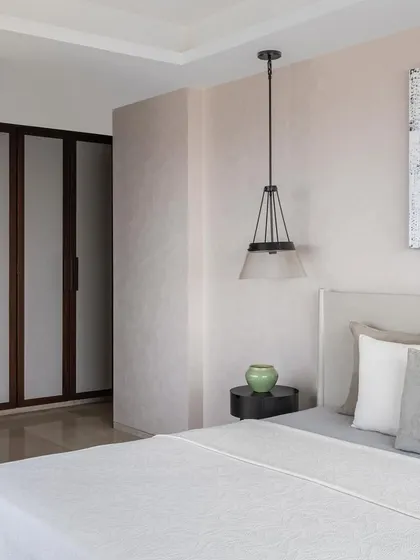 The master bedroom in Apartment 1600, a serene space with a neutral color palette and subtle textures.