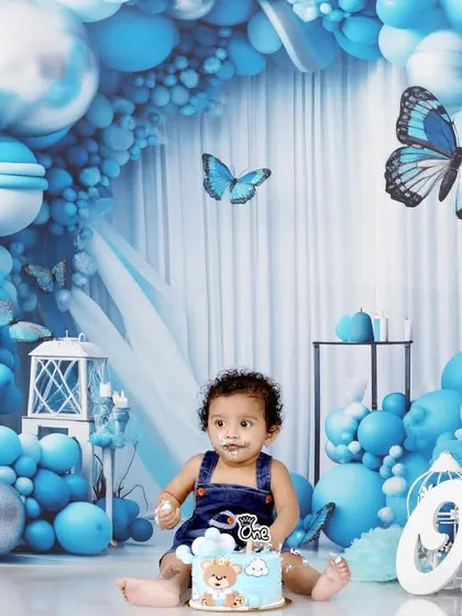 A classic cake smash portrait. With a little bit of frosting on his face, Naksha looks right at the camera, making for an adorable and memorable first birthday photo.