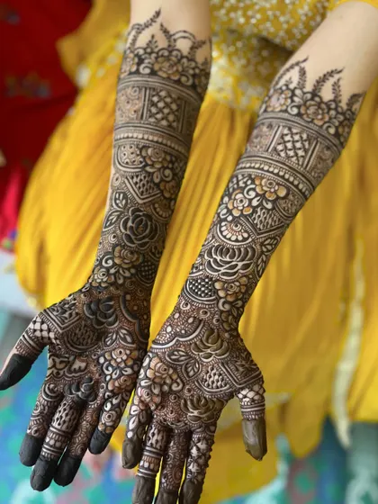 A complete view of the bridal henna, showing how the design flows beautifully from the palm to the forearm.