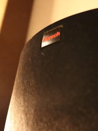 A close-up of the Klipsch logo on a speaker grille. Klipsch is another renowned audio brand I use to deliver powerful and dynamic sound for my home cinema installations.