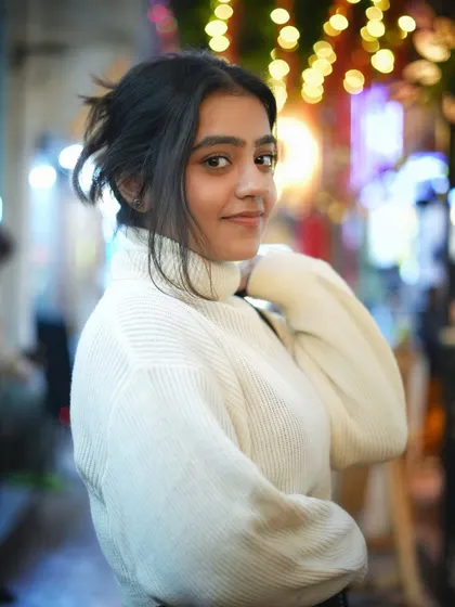 A slightly different angle of the previous pose, this shot captures another beautiful expression. The soft lighting is very flattering and adds to the cozy winter vibe.