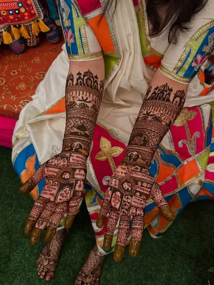 This custom design tells a story through a series of panels, including cityscapes and personal symbols. It's a wonderful way to represent the couple's journey together in their bridal henna.