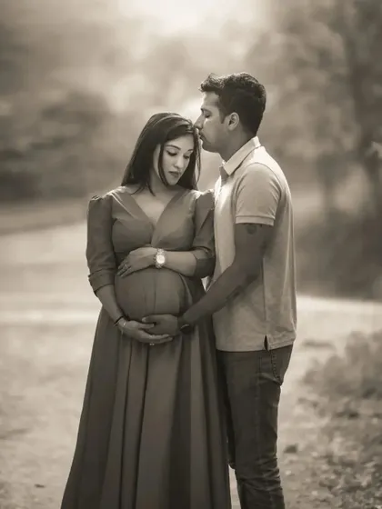 A duplicate of ID 21, this black and white version of a tender couple's portrait outdoors focuses on the husband's gentle kiss on his wife's forehead.