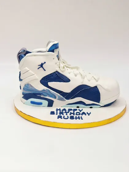A side view of the sculpted Nike sneaker cake, capturing the classic shoe silhouette perfectly.