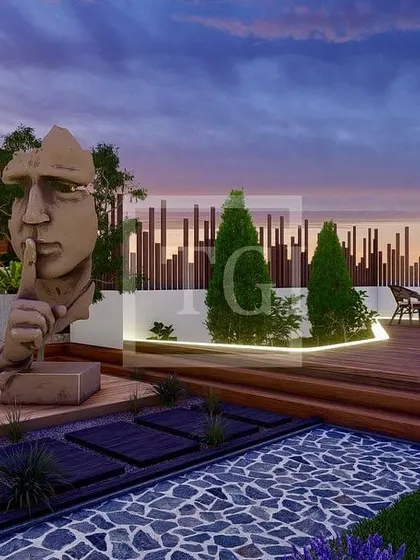 An evening view of the sculpture and seating area in the Noida project, demonstrating the impact of thoughtful lighting design.