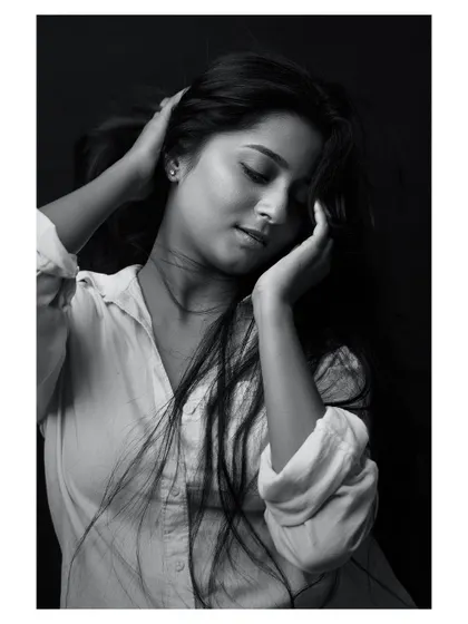 A classic portrait where the wind adds a touch of life. The black and white conversion brings out the texture of her hair and the honesty in her expression, resulting in a simple yet captivating headshot.