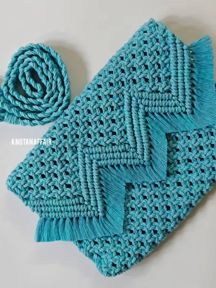 Another angle of the versatile turquoise macrame purse, showing how it folds over. The design is both functional and stylish, made with high-quality cotton cord.