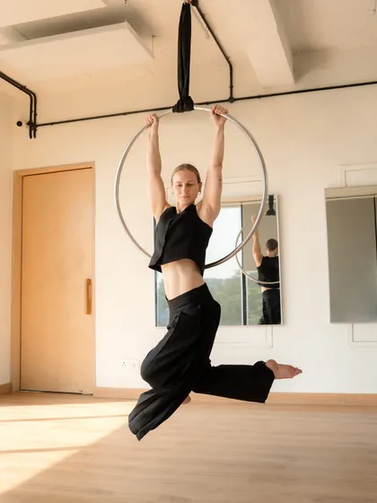 A moment of stillness on the aerial hoop. This pose requires significant core strength and control to hold with grace.
