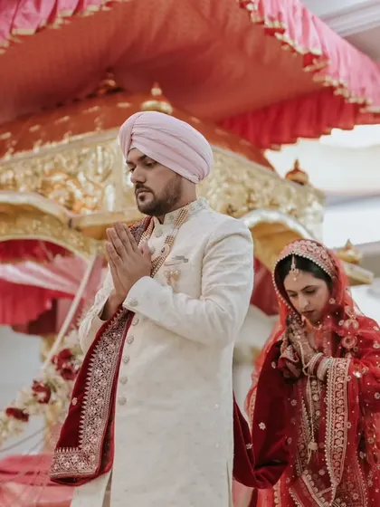 The couple taking their "laavan phere" around the Guru Granth Sahib, a central part of the Sikh wedding ritual.