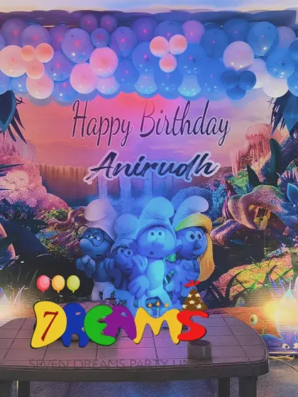 A unique Smurfs themed birthday decoration. I created a forest scene with a custom backdrop and a blue and white balloon arch to bring the Smurf village to the party.