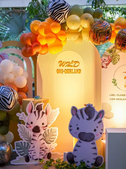 A "Wild One-derland" theme that combines cute zebra cutouts with warm, earthy colored balloons. This is another example of how I customize popular themes to be unique.