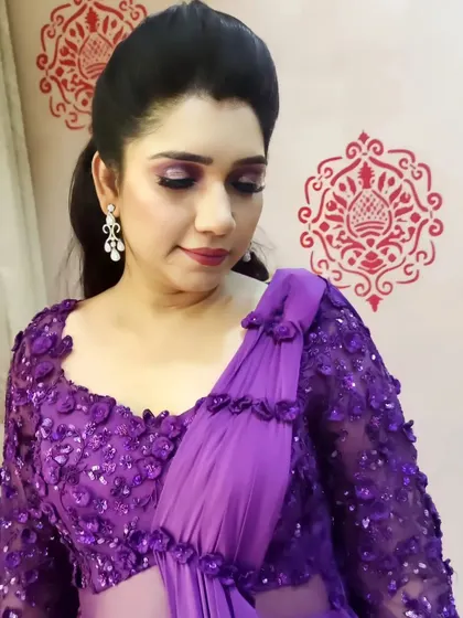 This client looks stunning in her purple gown. I complemented the outfit with a soft purple smokey eye, a subtle lip, and a sleek high ponytail for a modern and chic party look.