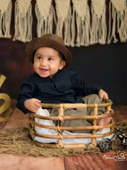Six months old and ready to take on the world. This little traveler's happy smile is the highlight of his rustic-themed milestone session.