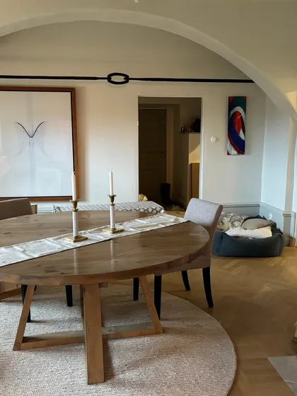 In this serene dining space, our custom circular carpet and table runner add subtle texture and elegance. The neutral tones of the rug complement the wooden furniture and minimalist art, creating a calm and sophisticated atmosphere.