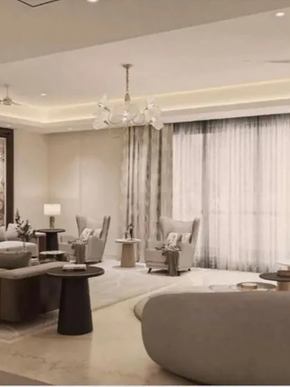 A view of the spacious living room in the Platinum Tower 4BHK, showing the flow towards the large windows and curtains.