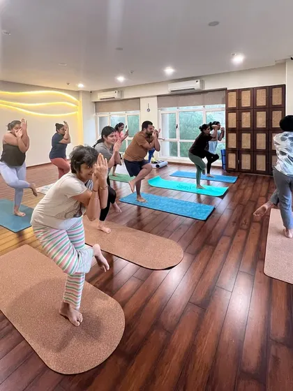 Finding our balance in Garudasana (Eagle Pose). This pose challenges our focus and strengthens our ankles and legs.