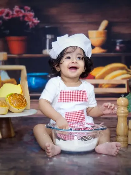 Let's get cooking. This little chef had a wonderful time playing with flour and kitchen props during his first birthday shoot, resulting in some delightfully candid and happy moments.