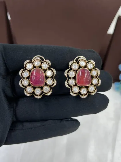 A close-up of our versatile floral stud earrings. These are available in multiple colors like emerald green and ruby red, and can be paired with many different necklaces.
