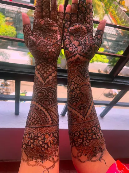 A stunning bridal henna design with intricate patterns covering the entire arm.