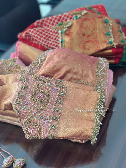 A collection of pink and red embroidered blouses.