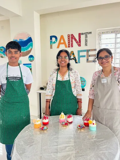 A family proudly presenting the dessert candles they made together. Our studio welcomes artists of all ages.