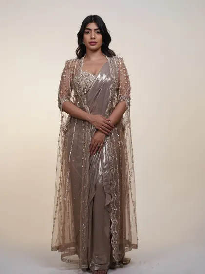 The full look of the metallic saree with its cape. The sheer, embroidered cape adds a layer of sophistication and makes the outfit even more special.