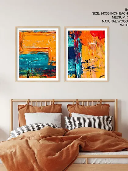 This set of two abstract prints brings warmth and energy to a bedroom. The natural wood frames echo the tones of the bed frame and side tables, creating a harmonious and stylish look.