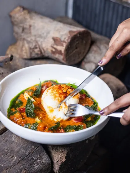 A knife and fork cut into the creamy Burrata, revealing its soft interior. This shot is a promise of the delicious texture and flavor of my signature Burrata Salad.